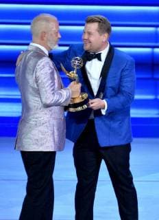 Ryan Murphy (L) accepts the Outstanding Directing for a Limited Series, Movie, or Dramatic Special award for The Assassination of Gianni Versace: American Crime Story from James Corden onstage during the 70th annual Primetime Emmy Awards at the Microsoft Theater in downtown Los Angeles on September 17, 2018.  LAP201809171119 JIMxRUYMEN