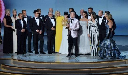 Ryan Murphy (C) surrounded by cast and crew, accepts the Ryan Murphy for The Assassination of Gianni Versace: American Crime Story onstage during the 70th annual Primetime Emmy Awards at the Microsoft Theater in downtown Los Angeles on September 17, 2018.  LAP201809172009 JIMxRUYMEN