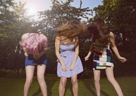 Excited female friends tossing hair at yard during sunny day  Copyright: JuttaxKlee fStopImages1603021