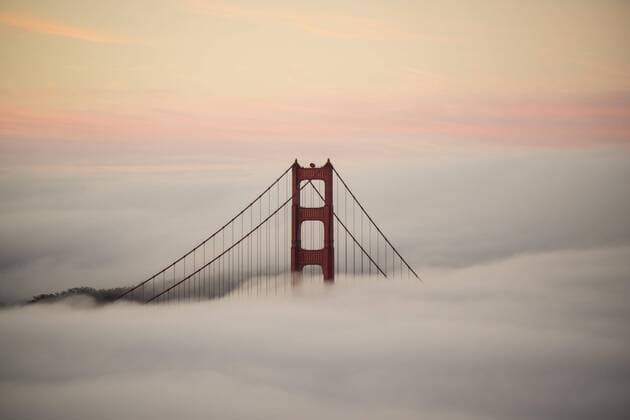 Golden Gate Bridge surrounded by fog during sunset, San Francisco, California, USA  Copyright: BennexOchs fStopImages1650043