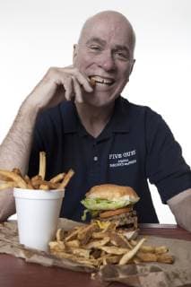 Jerry Murrell, CEO of Five Guys Famous Burgers and Fries samples one of Five Guys fresh cut Idaho french fries., Copyright: RandallxScott 4282600001