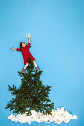 Girl decorating Christmas tree model released Symbolfoto  BAEF01629