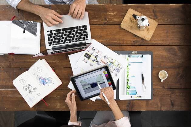 Mature couple working from their home office, using laptop and digital tablet model released Symbolfoto property released  FKF03074