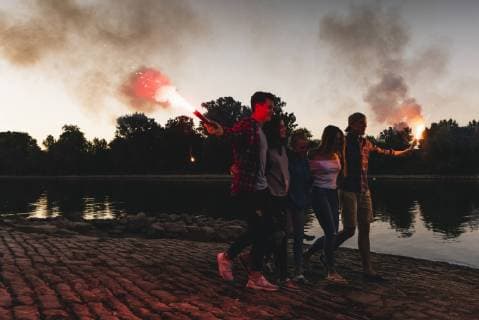 Group of friends walking at the riverside in the evening with torches model released Symbolfoto  UUF14854