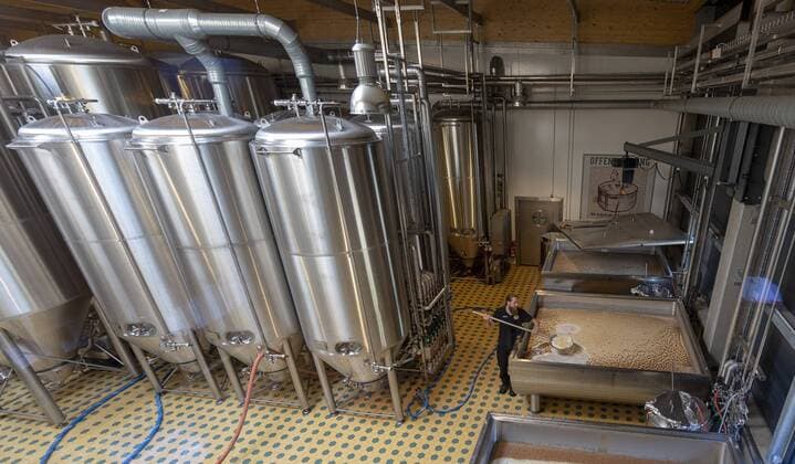 Hopping Island Ruegen jenskoehler The Chief Brewer Sebastian Riekehr 26 produces bitterness and brandy from the Gaerbottich in Ruegener Island Brewery in Rambin The beer is Island Kreide The brewery has been brewing rare beers with open fermentation and bottle aging since 2015