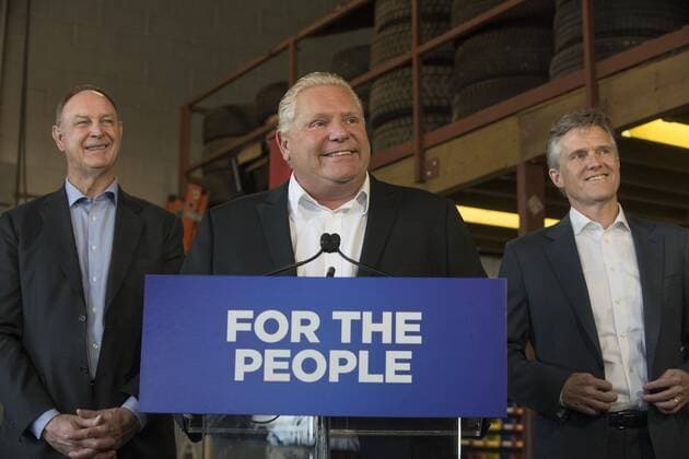 September 28, 2018 - Toronto, ON, Canada - TORONTO, ON - SEPTEMBER 28: Ontario Premier Doug Ford (centre), Minister of Transportation John Yakabushi (left) and Minister of Environment, Conservation and Parks, Rod Phillips, at announcement ending Drive Clean. The three were on hand at a press conference at a local Etobicoke garage. Rick Madonik Rick Madonik Toronto Canada  - ZUMAt14_ 20180928_zan_t14_004 Copyright: xTorontoxStarx