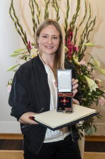 Julia Jentsch posing for a picture with the Cross of Merit of the Order of Merit of the Federal Republic of Germany in the Bellevue Palace in Berlin on 2 October 2018 Award of Merit in Berlin