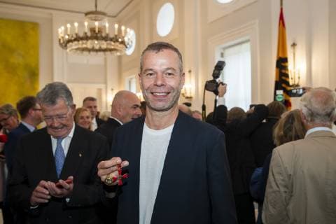 Wolfgang Tillmans poses for a picture after the awarding of the Cross of Merit of the Order of Merit of the Federal Republic of Germany at the Bellevue Palace in Berlin on 2 October 2018 Award of Merit in Berlin