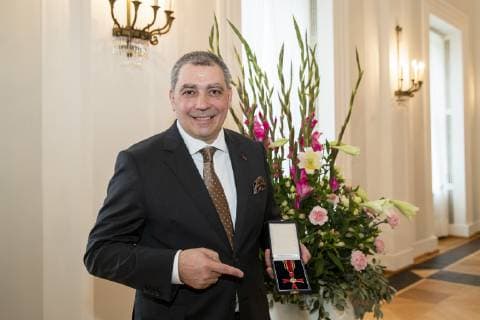 Star chef Christian Bau poses for a picture with the Cross of Merit of the Order of Merit of the Federal Republic of Germany at Schloss Bellevue in Berlin on 2 October 2018 Award of Merit in Berlin