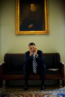 U.S. Senator and 2008 democratic Presidential candidate Barack Obama sits beneath a painted portrait of Arthur Pue Gorman, a Senator from Maryland at the end of the 19th century, and talks on a cell phone outside the Senate chamber in the U.S. Capitol, Friday, March 23, 2007., Washington D.C. USA Copyright: JayxL.xClendenin 9582600004