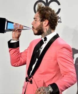 Rapper Post Malone appears backstage with his award for Favorite Male Artist - Pop Rock, during the 46th annual American Music Awards at the Microsoft Theater in Los Angeles on October 9, 2018.  LAP20181009555 JIMxRUYMEN