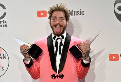 Rapper Post Malone appears backstage with his award for Favorite Male Artist - Pop Rock, during the 46th annual American Music Awards at the Microsoft Theater in Los Angeles on October 9, 2018.  LAP20181009556 JIMxRUYMEN