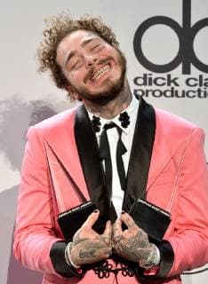 Rapper Post Malone appears backstage with his award for Favorite Male Artist - Pop Rock, during the 46th annual American Music Awards at the Microsoft Theater in Los Angeles on October 9, 2018.  LAP20181009547 JIMxRUYMEN