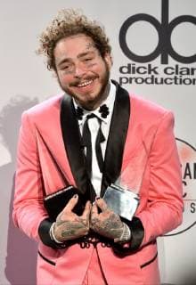 Rapper Post Malone appears backstage with his award for Favorite Male Artist - Pop Rock, during the 46th annual American Music Awards at the Microsoft Theater in Los Angeles on October 9, 2018.  LAP20181009548 JIMxRUYMEN