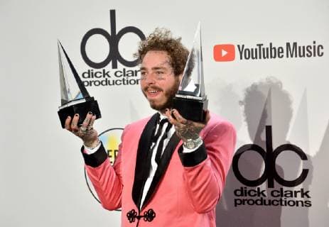 Rapper Post Malone appears backstage with his award for Favorite Male Artist - Pop Rock, during the 46th annual American Music Awards at the Microsoft Theater in Los Angeles on October 9, 2018.  LAP20181009553 JIMxRUYMEN