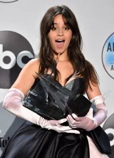 Singer Camila Cabello appears backstage with her award for New Artist of the Year presented by Capital One Savor Card, during the 46th annual American Music Awards at the Microsoft Theater in Los Angeles on October 9, 2018.  LAP20181009623 JIMxRUYMEN