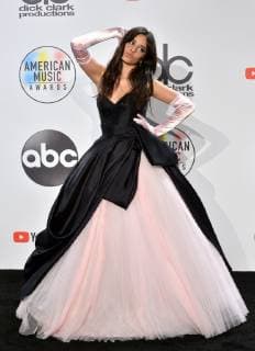 Singer Camila Cabello appears backstage with her award for New Artist of the Year presented by Capital One Savor Card, during the 46th annual American Music Awards at the Microsoft Theater in Los Angeles on October 9, 2018.  LAP20181009628 JIMxRUYMEN