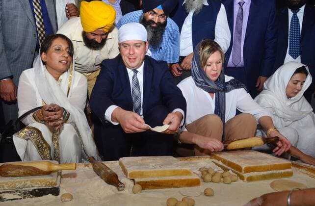 AMRITSAR, INDIA - OCTOBER 10: Andrew Scheer Leader Of Opposition (Conservative Party) in Canada along with his wife Jill Scheer prepares food for langar (a communal meal) at Golden Temple on October 10, 2018 in Amritsar, India. (Photo by Sameer Sehgal Hindustan Times) Canada Leader Of Opposition And Conservative Party Leader Andrew Scheer And With His Wife Jill Scheer Pay Obeisance At Golden Temple