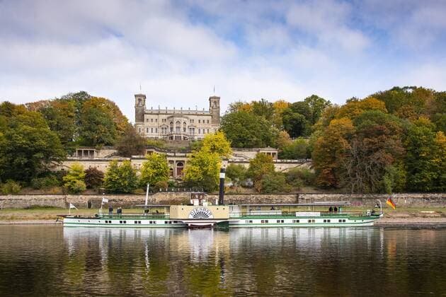 The castle Albrechtsberg on the river Elbe in Dresden of the state capital of Saxony In the castle park autumnally colored trees On the Elbe the historic steamboat Diesbar Photo Volker Hohlfeld Castle Albrechtsberg on the Elbe