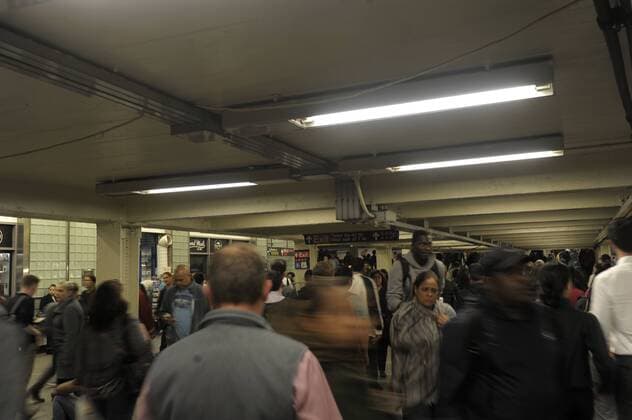 U TImes Square Station Passengers walk in a subway to other New York subway train tracks