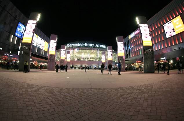 Night view of the Mercedes Benz Arena Overview on illuminated Mercedes Benz Arena and new Verti Music Hall in Berlin with audience and lighting from the outside at night on 19 10 18 Berlin Berlin Germany Mercedes Benz Arena