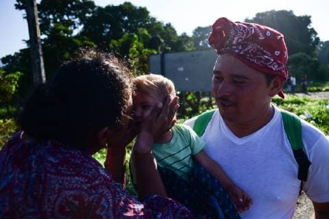 October 24, 2018 - Mapastepec, Chiapas, Mexico - A Mexican woman kisses a little boy and his uncle at the town of Acacoyagua while traveling with thousands of Central American migrants continued their journey toward the US border Thursday, reaching the coastal town of Mapastepec, in Chiapas, Mexico, An estimated 7,200 migrants from Honduras and other countries have pressed on, sleeping on roads, traveling on rafts, going without food and water and facing police and threats from President Trump, who called them a threat and vowed to send troops to the border with Mexico. Mapastepec Mexico - ZUMAl113 20181024_zap_l113_017 Copyright: xMiguelxJuarezxLugox