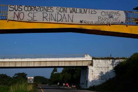 October 26, 2018 - Arriaga, Chiapas, Mexico - A Honduran migrant family trying to reach the city of Arriaga, ask for a lift to cars passing by the coastal highway in Chiapas , Mexico, Friday . A caravan of thousands of Honduran migrants continued their trek crossing Mexico, toward the USA. The billboard posted at bridge reads You valiant hearts won t give up, Chiapas without borders Arriaga Mexico - ZUMAl113 20181026_zap_l113_003 Copyright: xMiguelxJuarezxLugox