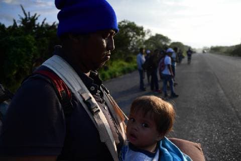 October 29, 2018 - Santiago Niltepec, Oaxaca, Mexico - A father and son wait for a hickjacking as Central American migrants continue their trek toward the US, riding on top of a trucks Monday to the town of Santiago Niltepec in Oaxaca state on Monday. As the number of migrants in the caravan has dropped as people become discouraged or too tired to carry on, President Trump is planning to send5200 American troops to the border to stop what he calls an Ã¢â‚¬oeinvasion. Santiago Niltepec Mexico - ZUMAl113 20181029_zap_l113_007 Copyright: xMiguelxJuarezxLugox