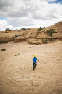 Boy Riding His Bike in the Desert of Moab Southern Utah, United States model released Symbolfoto Copyright: ScottxMarkewitz MASC000243