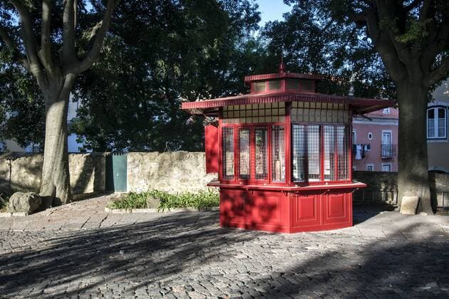 Red kiosk on the viewpoint Miradouro do Castelo de Sao Jorge in the district Alfama Lisbon Portugal