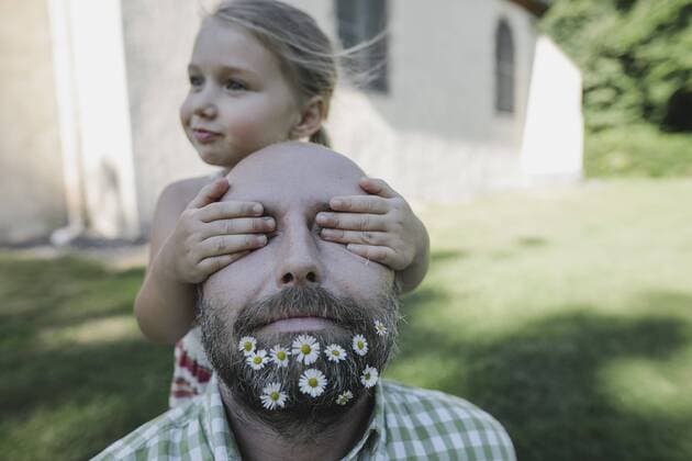 Little girl s hands covering eyes of mature man with daisies in his beard model released Symbolfoto  KMKF00468