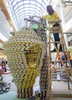 (181104) -- VANCOUVER, Nov. 4, 2018 -- A participant works on the can sculpture during the Canstruction event in Vancouver, Canada, Nov. 3, 2018. Some 13 teams competed with their sculpture designs by using donated cans in the annual event. ) (lrz) CANADA-VANCOUVER- CANSTRUCTION EVENT LiangxSen 