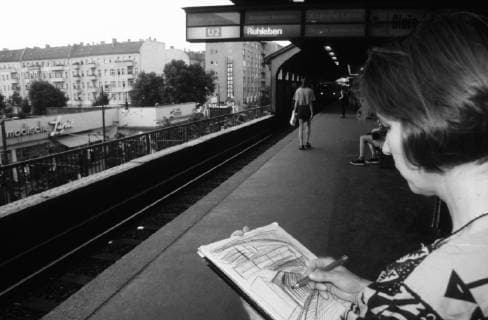 Woman drawing on the underground station Schönhauser Allee in Berlin Prenzlauer Berg Recording date estimated U Bahnhof Schönhauser Allee