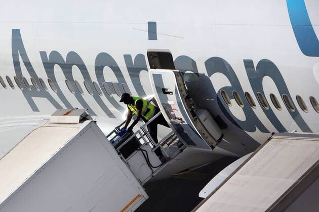 Employees of LSG Lufthansa Service company Sky Chefs loading a scheduled aircraft of American Airlines at Frankfurt Airport FRA Hessen Germany