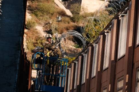 November 7, 2018 - Nogales, Arizona, USA - The US Army laying barbed wire on top of the border wall at international border station in Nogales, Arizona. The soldiers are part of the 5,000 troops that President Trump has ordered the Pentagon to dispatch to the Southwest border to assist the US Border Patrol in advance of the possible arrival of caravans of Central American migrants. Nogales USA - ZUMAb411 20181107_zap_b411_001 Copyright: xChristopherxBrownx