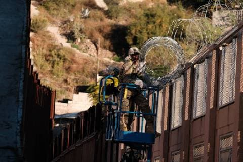 November 7, 2018 - Nogales, Arizona, USA - The US Army laying barbed wire on top of the border wall at international border station in Nogales, Arizona. The soldiers are part of the 5,000 troops that President Trump has ordered the Pentagon to dispatch to the Southwest border to assist the US Border Patrol in advance of the possible arrival of caravans of Central American migrants. Nogales USA - ZUMAb411 20181107_zap_b411_024 Copyright: xChristopherxBrownx