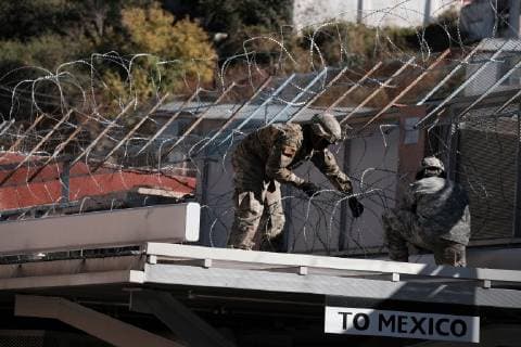 November 7, 2018 - Nogales, Arizona, USA - The US Army laying barbed wire on top of the border wall at international border station in Nogales, Arizona. The soldiers are part of the 5,000 troops that President Trump has ordered the Pentagon to dispatch to the Southwest border to assist the US Border Patrol in advance of the possible arrival of caravans of Central American migrants. Nogales USA - ZUMAb411 20181107_zap_b411_014 Copyright: xChristopherxBrownx