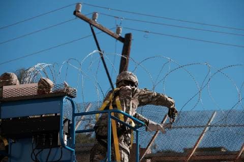 November 7, 2018 - Nogales, Arizona, USA - The US Army laying barbed wire on top of the border wall at international border station in Nogales, Arizona. The soldiers are part of the 5,000 troops that President Trump has ordered the Pentagon to dispatch to the Southwest border to assist the US Border Patrol in advance of the possible arrival of caravans of Central American migrants. Nogales USA - ZUMAb411 20181107_zap_b411_022 Copyright: xChristopherxBrownx