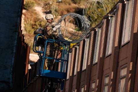 November 7, 2018 - Nogales, Arizona, USA - The US Army laying barbed wire on top of the border wall at international border station in Nogales, Arizona. The soldiers are part of the 5,000 troops that President Trump has ordered the Pentagon to dispatch to the Southwest border to assist the US Border Patrol in advance of the possible arrival of caravans of Central American migrants. Nogales USA - ZUMAb411 20181107_zap_b411_008 Copyright: xChristopherxBrownx