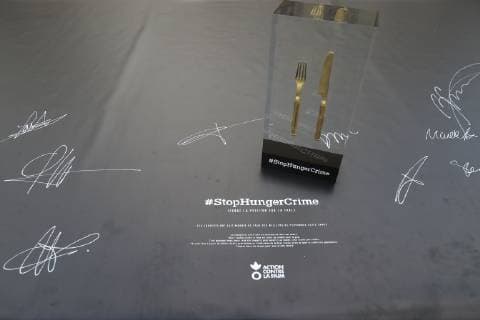 Illustration couvert de table arme de guerre ( fait a partir de douilles ) sur la nappe petition avec signatures NEWS : Stop Hunger Crime - Nouvelle campagne Action contre la Faim - Paris - 12 11 2018 GwendolineLeGoff Panoramic 