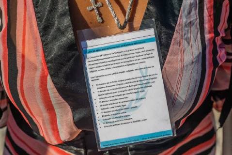 Nov 14, 2018 - Tijuana, Mexico - Asylum seeker from Honduras wears a card for the Human Rights of Refugee Persons at the US Mexico border in Tijuana. Tijuana Mexico - ZUMAs157 20181114_tim_s157_002 Copyright: xVitoxDixStefanox