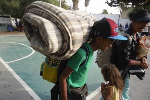 November 15, 2018 - San Diego, California, USA - After waiting for hours in line, a migrant family who arrived late Thursday, is accepted into the temporary shelter at the Unidad Deportiva Benito Juarez, a municipal gym, in Tijuana. San Diego USA - ZUMAs44_ 20181115_zaf_s44_002 Copyright: xNelvinxC.xCepedax