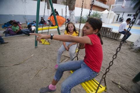November 15, 2018 - San Diego, California, USA - Two girls play on the swing just outside the temporary shelter set up at the Unidad Deportiva Benito Juarez in Tijuana. San Diego USA - ZUMAs44_ 20181115_zaf_s44_005 Copyright: xNelvinxC.xCepedax