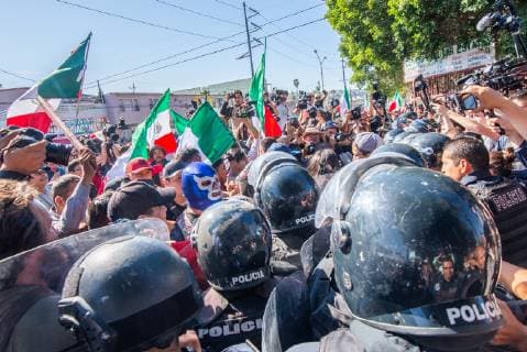 November 18, 2018 - Demonstrators briefly skirmish with police in Tijuana, Mexico on November 18,2018. They are protesting the arrival of thousands of .asylum seekers from Central America, aka the MIgrant Caravan . The police blockade was a block away from Unidad Deportiva Benito Juarez makeshift shelter, where some asylum seekers are being housed. - ZUMAs157 20181118_znp_s157_014 Copyright: xVitoxDixStefanox