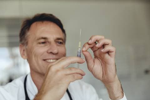 Doctor preparing injection, filling syringe model released Symbolfoto property released  MFF04468
