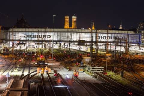 Illuminated central station with tracks at night back Frauenkirche Munich Germany Europe Copyright: imageBROKER/MarcxRasmus iblmra04743201.jpg