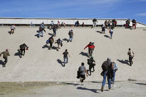 Migrant caravan Migrants from Central America climb a steep embankment in Tijuana, Mexico, toward the U.S. border checkpoint on Nov. 25, 2018. 