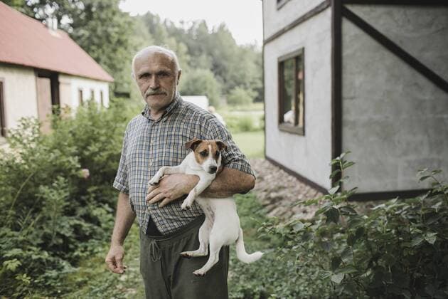 Portrait of senior man holding Jack Russell Terrier in garden model released Symbolfoto property released  KMKF00559