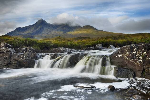United Kingdom, Scotland, Scottish Highlands, Isle Of Skye, Waterfall at Sligachan river with view to the Cuillin mountains  RUEF02006