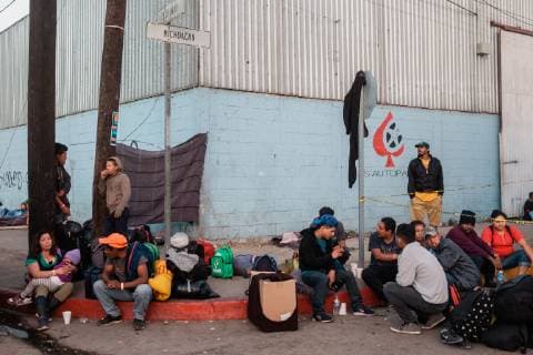Migrants that are part of the caravan from Central America sit outside of the makeshift migrant shelter at Unidad Deportiva Benito Juarez Stadium on November 26, 2018 in Tijuana, Mexico. Sunday afternoon, some migrants protesting a backlog of asylum claims rushed toward the border and were met with tear gas.  TIJ2018112602 ARIANAxDREHSLER